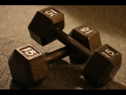 two 15-pound dumbbells on a dark background