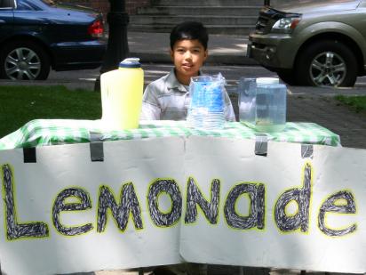 A young entrepreneur selling lemonade on a hot day