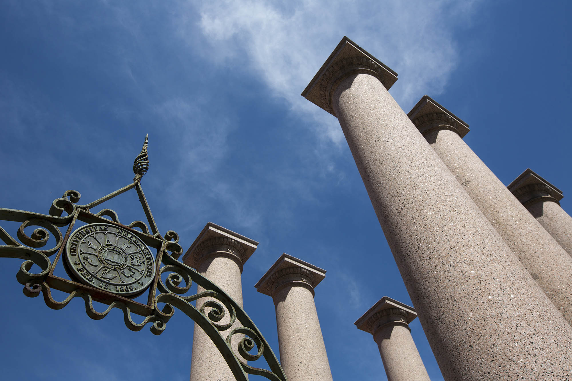 Skyward image of pillars with blue sky above