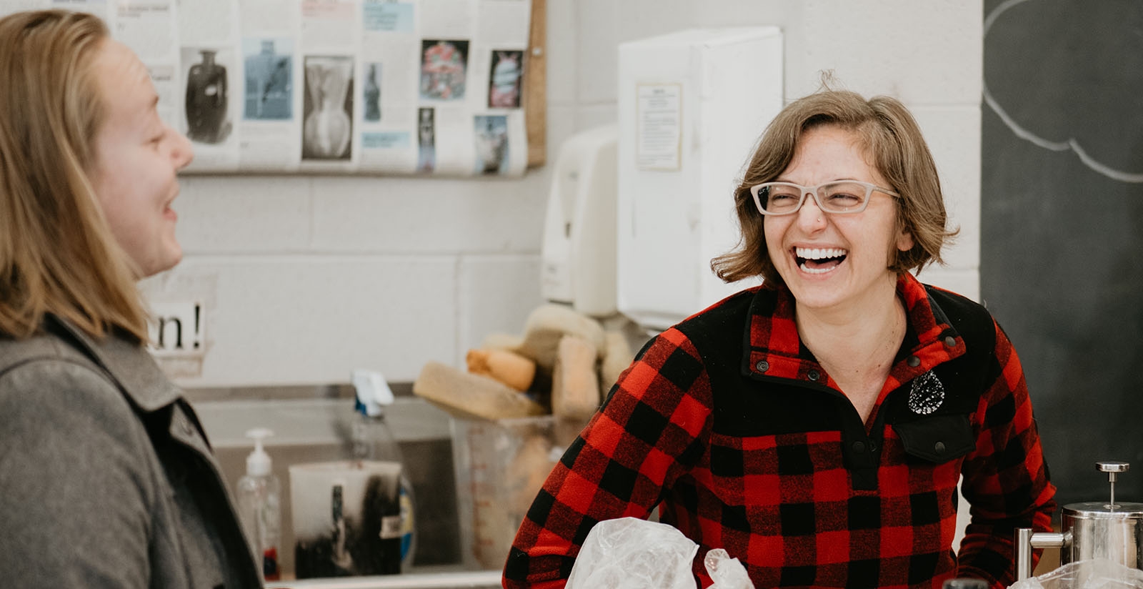 Image of two students in a ceramics master class