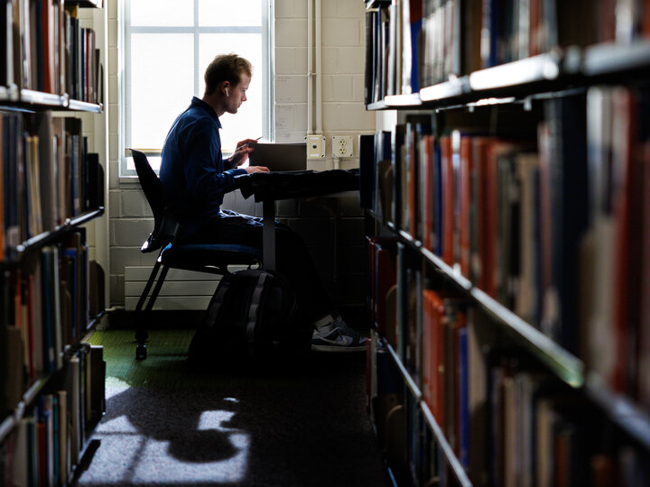 student in library