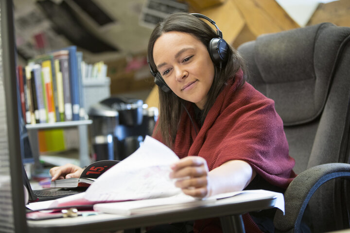 Interior Design student studying at a desk in the library.