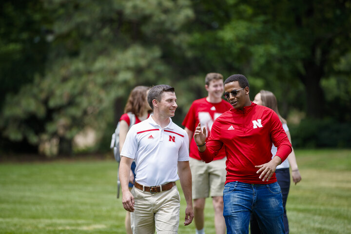 Students in a discussion while walking.